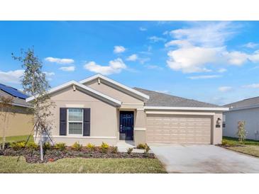 Charming single-story home with a well-manicured lawn, inviting entry and two car garage at 865 Citrus Reserve Blvd, Davenport, FL 33837