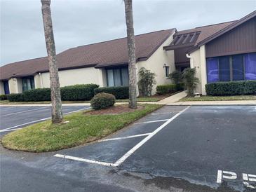 Condominium exterior featuring front parking and landscaping at 101 Grand Plaza Dr # P40, Orange City, FL 32763