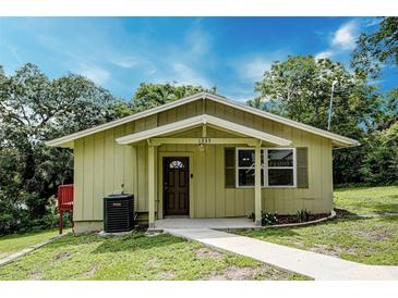 Charming single-story home featuring a cozy front porch and well-maintained lawn at 1335 E 3Rd Ave, Mount Dora, FL 32757