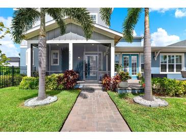 Beautiful home exterior with lush landscaping, walkway and screened in front porch at 14366 Walcott Ave, Orlando, FL 32827