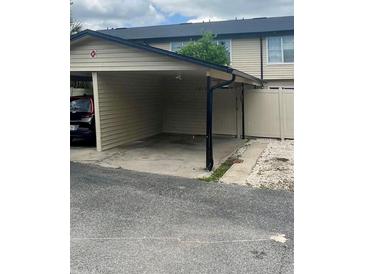 Attached carport with space for parking, providing convenient covered access to the home at 1815 Townhall Ln # 1815, Orlando, FL 32807