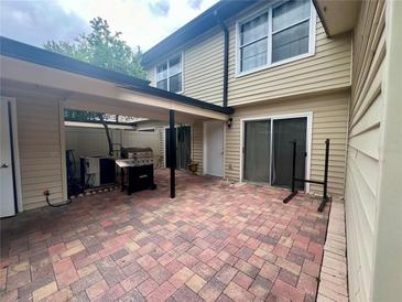 Paver patio with built-in grill and covered entertaining space at 1815 Townhall Ln # 1815, Orlando, FL 32807