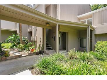 Inviting entrance with covered parking and lush landscaping enhances this home's curb appeal at 2142 Woodbridge Rd, Longwood, FL 32779