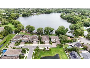 Stunning aerial view of lakeside community featuring beautiful homes, lush trees, and tranquil waters at 2922 Reef Knot Pl, Winter Park, FL 32792
