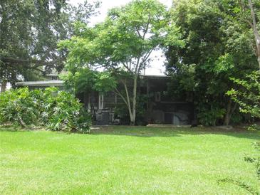 Quaint home with lush greenery, offering privacy and a serene setting at 3000 Surfside Way, Orlando, FL 32805