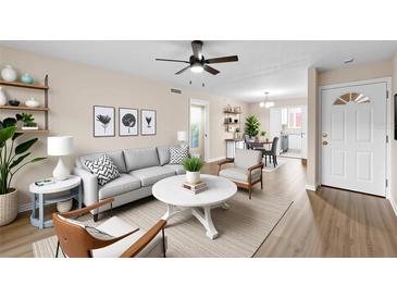 Bright living room features contemporary furnishings, modern decor and an open layout with hardwood style floors at 4312 Lake Underhill Rd # 19-B, Orlando, FL 32803