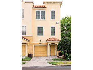 Charming two-story townhouse featuring a private garage and covered entrance at 8024 Cool Breeze Dr # 132, Orlando, FL 32819