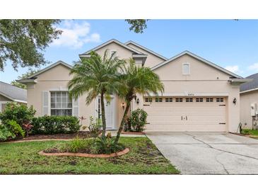 Charming single-story home featuring a well-manicured lawn and attached two-car garage at 8495 Lake Amhurst Trl, Orlando, FL 32829
