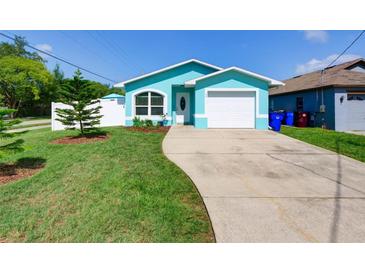 Charming, updated single-Gathering home with a well-manicured lawn, new landscaping, and an attached garage at 1618 Oregon Ave, St Cloud, FL 34769