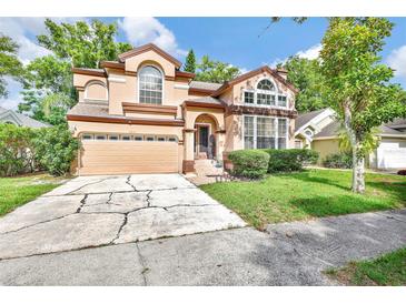Two-story home with a two-car garage and a well-manicured front yard at 2971 Cayman Way, Orlando, FL 32812