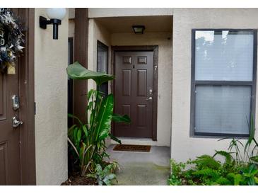 Inviting front door entrance with lush greenery and a welcoming mat at 3012 S Semoran Blvd # S, Orlando, FL 32822