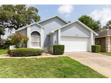 Charming single-story home featuring a two-car garage, landscaped yard, and light blue paint at 342 Lakebreeze Cir, Lake Mary, FL 32746