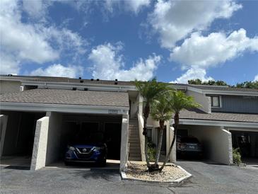 Charming condo featuring private covered parking, well-maintained landscaping, and convenient stair access at 5395 Vineland Rd # S, Orlando, FL 32811