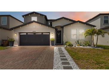 Beautiful home exterior with a brick driveway and manicured landscaping at 5639 Timber Meadow Way, St Cloud, FL 34771