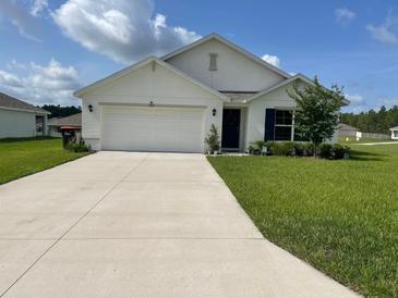 Charming single-story home featuring a well-maintained lawn and a two car garage at 7172 Sw 135Th Pl, Ocala, FL 34473