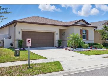 Charming single-story home with well-maintained landscaping and a two-car garage at 914 Fallon Hills Dr, Haines City, FL 33844