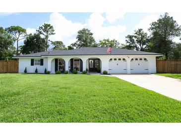 Charming single-story home with a well-manicured lawn and attached three-car garage at 300 Royal Palm Ct, Longwood, FL 32779