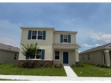Two-story home boasts well-manicured lawn and blue shutters at 5274 Scrub Mint Ln, Apopka, FL 32712