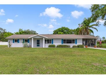 Charming single-story home with blue shutters and a well-manicured lawn at 5984 Ed Harris Ct, St Cloud, FL 34771