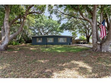 Charming single-story home with mature trees and a well-maintained front yard offering a serene setting at 845 Edgewater Cir, Eustis, FL 32726