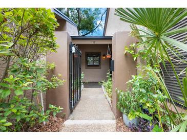 Charming entrance with a gated front patio area, mature landscaping, and a cozy feel at 940 Douglas Ave # 132, Altamonte Springs, FL 32714