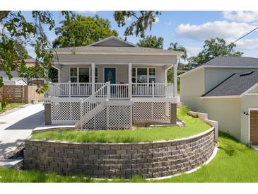 Charming single-story home featuring a welcoming front porch and well-maintained landscaping at 1031 Morningside Dr, Eustis, FL 32726