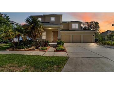 Inviting two-story home with a three-car garage and lush landscaping at 13519 Bicton Ln, Windermere, FL 34786