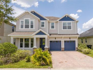 Charming two-story home with a brick paver driveway and manicured landscaping in a beautiful neighborhood at 5161 Dove Tree St, Orlando, FL 32811
