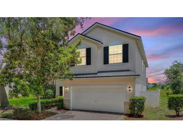 Two story home with well-manicured landscaping, attached garage and neutral paint at 546 Windsor Pl, Davenport, FL 33896