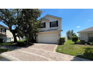 Charming two-story home with brick driveway, attached garage, and well-maintained landscaping at 546 Windsor Pl, Davenport, FL 33896