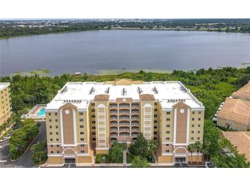 Beautiful condo with balconies and stunning lake views, complemented by lush landscaping at 6336 Buford St # 207, Orlando, FL 32835