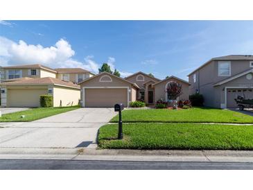 Charming single-story home featuring a well-manicured lawn and a two-car garage at 14831 Yorkshire Run Dr, Orlando, FL 32828
