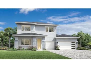 Modern two-story home with a three car garage, lovely landscaping and contemporary design at 1880 Stonecliff Dr, Apopka, FL 32703