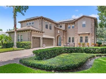 Stunning two-story home with well-manicured landscaping and three-car garage at 25537 High Hampton Cir, Sorrento, FL 32776