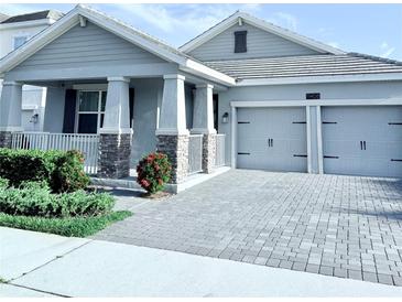 Beautiful home with a two-car garage and a manicured front yard at 11408 Satire St, Orlando, FL 32832