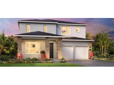Charming two-story home boasting stone accents, a well-manicured lawn, and an inviting two-car garage at 1515 Stonecliff Dr, Apopka, FL 32703