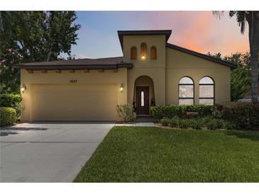 Charming home featuring a well-manicured lawn, two-car garage, and a unique architectural design at 3637 Foxchase Dr, Clermont, FL 34711