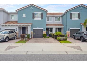 Charming blue two-story townhomes, each with a private garage and well-manicured landscaping at 366 Reed Grass Dr, Oviedo, FL 32765
