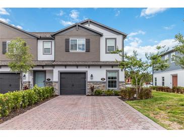 Charming two-story home with a two-car garage and a brick driveway at 378 Cape Honeysuckle Pl, Sanford, FL 32771