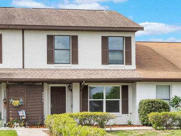 Charming two-story townhouse with a well-maintained front yard and inviting entrance at 9494 Lake Lotta Cir, Gotha, FL 34734
