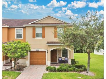 Charming two-story home with a well-maintained front yard, covered entrance, and attached garage at 10656 Savannah Plantation Ct, Orlando, FL 32832