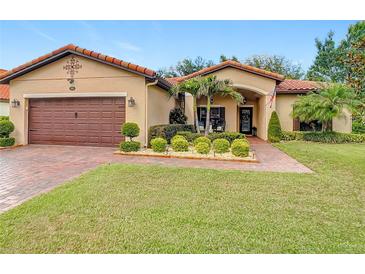 Charming one-story home with a well-manicured lawn, tile roof, and inviting front entrance at 169 Verde Way, Debary, FL 32713