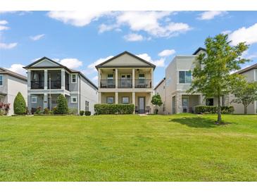 Charming two-story home featuring a well-maintained lawn and inviting double balconies at 1787 White Feather Loop, Oakland, FL 34787