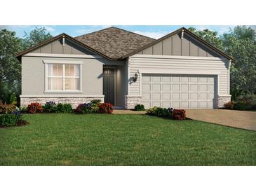 Charming single-Gathering home with a two-car garage, stone accents, and beautifully landscaped front yard at 3140 Legends Preserve Dr, Daytona Beach, FL 32124