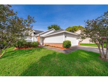 Charming single-Gathering home with a well-maintained lawn and landscaping and an attached two-car garage at 6512 Grosvenor Ln, Orlando, FL 32835