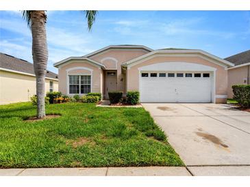 Charming single-Gathering home featuring a manicured front lawn and a two-car garage at 8152 Fan Palm Way, Kissimmee, FL 34747