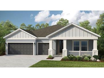 Charming single-story home with a two-car garage, covered porch, and well-maintained lawn at 854 Junonia Blvd, New Smyrna Beach, FL 32168