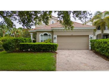 Charming single-Gathering home featuring a two-car garage and a well-manicured lawn and mature landscaping at 8108 Via Bella Notte, Orlando, FL 32836