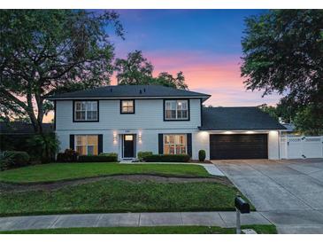 Charming two-story home with a well-manicured lawn and inviting curb appeal against a colorful dusk sky at 1105 Appleton Ave, Orlando, FL 32806