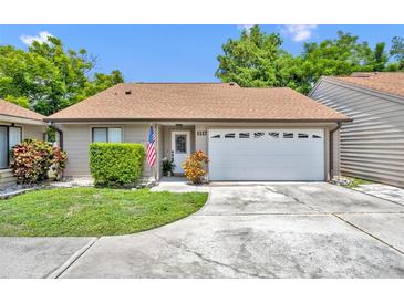Charming single-story home with attached garage, well-kept lawn, and inviting curb appeal at 1117 Park Green Pl, Winter Park, FL 32789